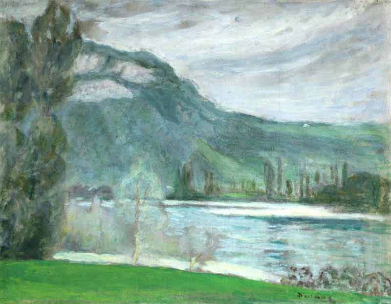 Green riverbank to foreground with tree to left of painting. Far bank and mountains to the distance beneath a cloudy sky.